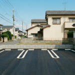 徳島県徳島市の住宅街にある駐車場舗装の施工事例。アスファルト舗装と、車両同士の間隔を広く確保できる最新のU字型白線。